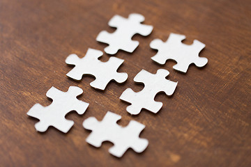 Image showing close up of puzzle pieces on wooden surface