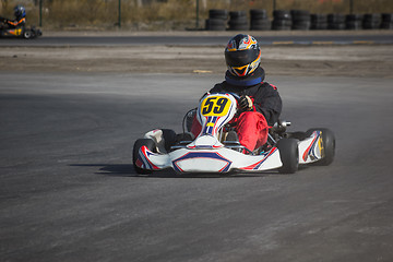 Image showing Karting - driver in helmet on kart circuit