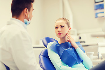 Image showing male dentist with woman patient at clinic