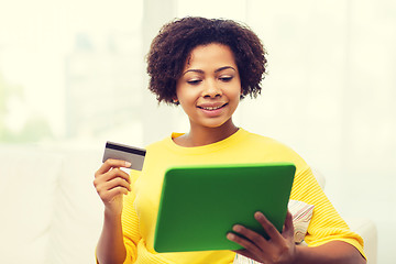 Image showing happy african woman with tablet pc and credit card