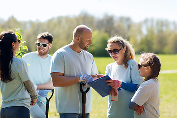 Image showing group of volunteers planting trees in park