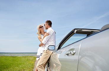 Image showing happy couple hugging near cabriolet car at sea