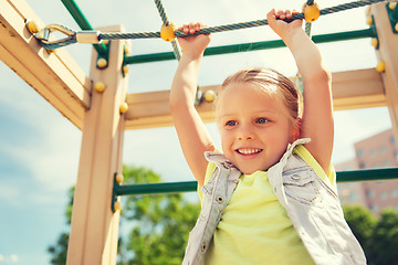 Image showing happy little girl climbing on children playground