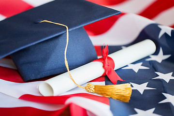 Image showing bachelor hat and diploma on american flag