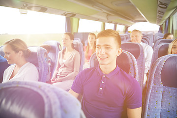 Image showing happy young man sitting in travel bus or train