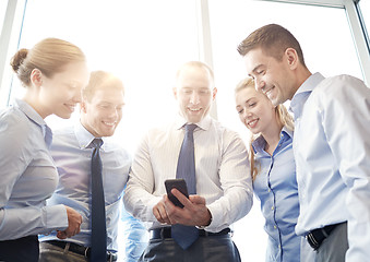 Image showing happy businesspeople with smartphone