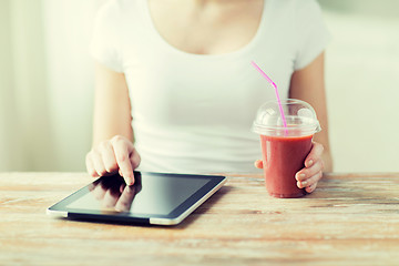 Image showing close up of woman with tablet pc and smoothie