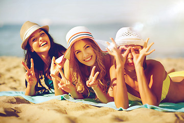 Image showing girls sunbathing on the beach