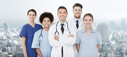 Image showing group of happy doctors over blue background