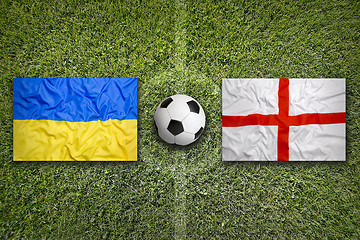 Image showing Ukraine vs. England flags on soccer field