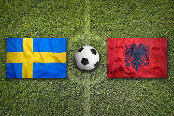 Image showing Sweden vs. Albania flags on soccer field