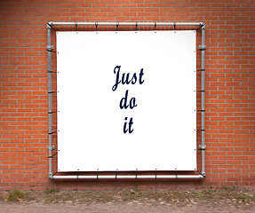 Image showing Large banner with inspirational quote on a brick wall