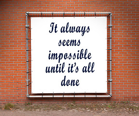 Image showing Large banner with inspirational quote on a brick wall