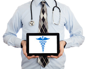 Image showing Doctor holding tablet - Caduceus symbol