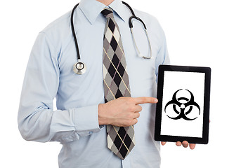 Image showing Doctor holding tablet - Warning! Biohazard!