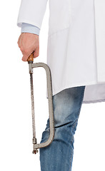 Image showing Crazy doctor is holding a big saw in his hands