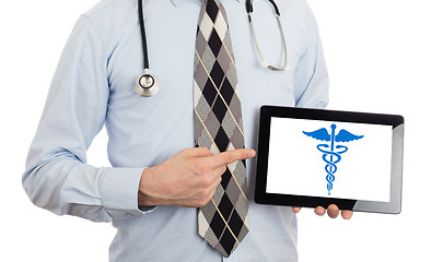 Image showing Doctor holding tablet - Caduceus symbol