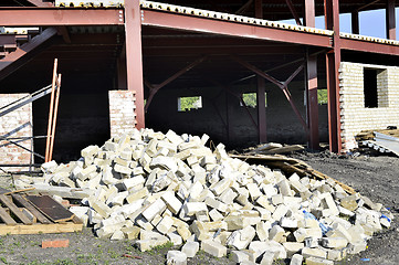 Image showing Construction materials and waste on the background of building under construction