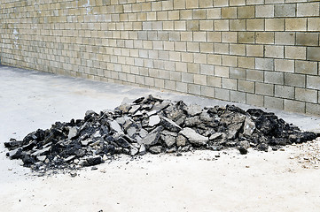 Image showing Old asphalt pieces stacked in a pile on the sidewalk