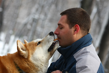 Image showing Man with dog and cracker