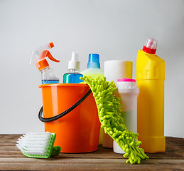 Image showing Bucket with cleaning items on light background