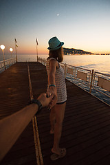 Image showing Girl holding a hand man on the beach