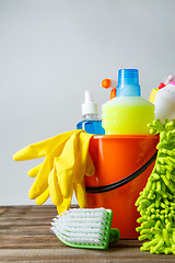 Image showing Bucket with cleaning items on light background