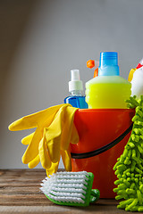 Image showing Bucket with cleaning items on light background