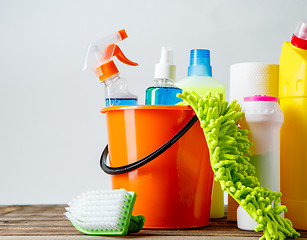 Image showing Bucket with cleaning items on light background