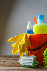 Image showing Bucket with cleaning items on light background