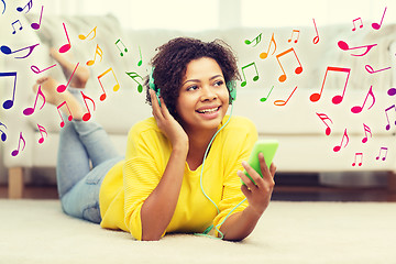 Image showing happy african woman with smartphone and headphones