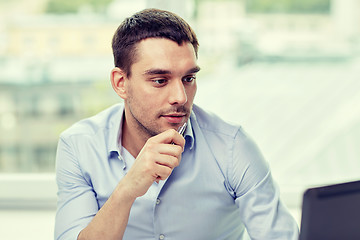 Image showing young businessman with laptop computer at office