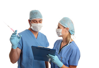 Image showing Surgeons consulting talking over medical records