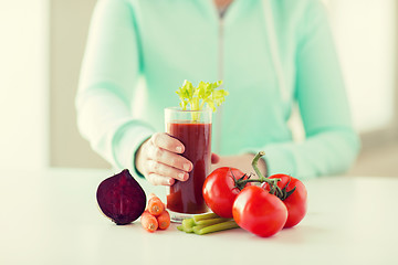 Image showing close up of woman hands with juice and vegetables