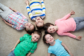 Image showing happy smiling little children lying on floor