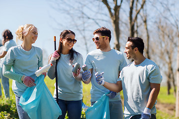 Image showing volunteers with garbage bags cleaning park area