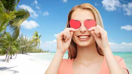 Image showing happy young woman with red heart shapes on eyes