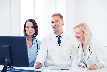 Image showing doctors looking at computer on meeting