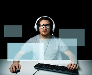 Image showing man in headset playing computer video game