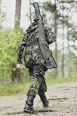 Image showing young soldier or hunter with gun in forest