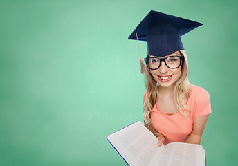 Image showing student woman in mortarboard with encyclopedia