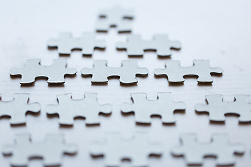 Image showing close up of puzzle pieces on table