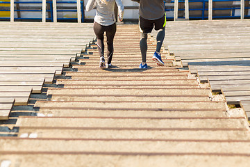 Image showing close up of couple running downstairs on stadium