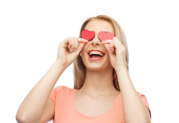 Image showing happy young woman with red heart shapes on eyes