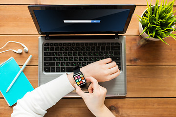 Image showing close up of woman with smart watch and laptop