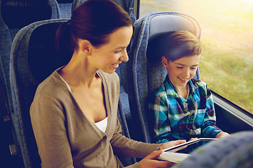 Image showing happy family with tablet pc sitting in travel bus