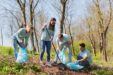 Image showing volunteers with garbage bags cleaning park area