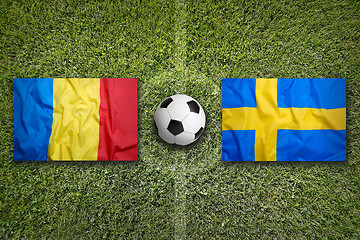 Image showing Romania vs. Sweden flags on soccer field