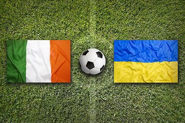 Image showing Ireland vs. Ukraine flags on soccer field