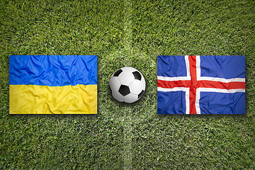 Image showing Ukraine vs. Iceland flags on soccer field